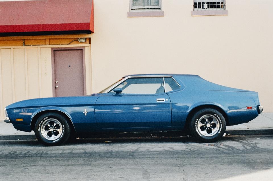 Blue classic coupe with a straight, clean door panel