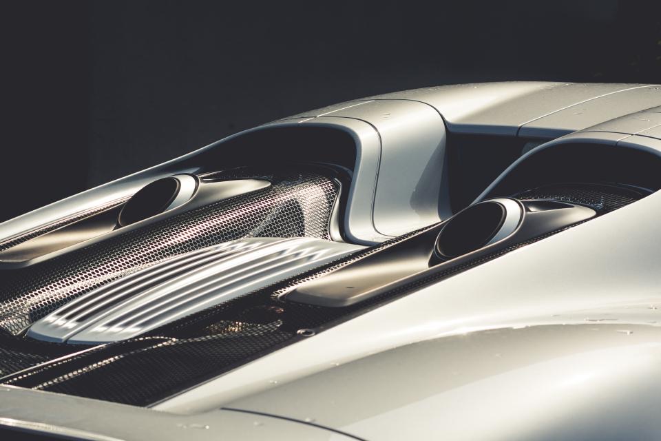 A smooth, curved car panel with a clean straight reflection across it