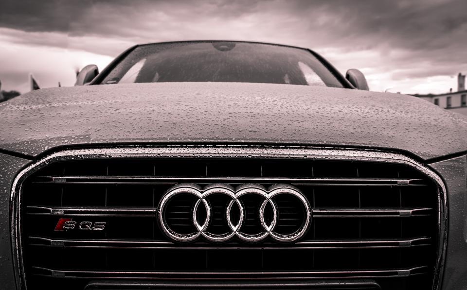Hood of a dark car beaded with water after a storm